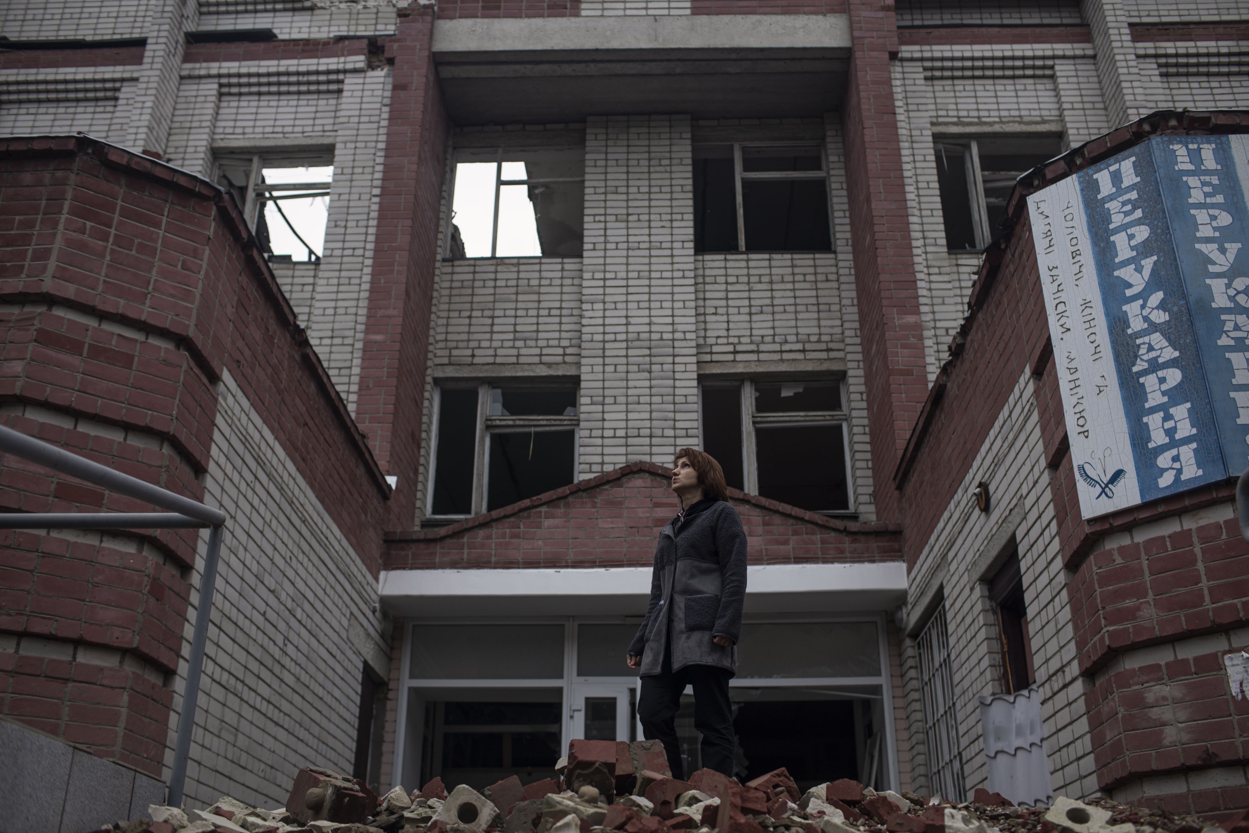 A member of staff stands outside the Chernihiv hospital, which was badly damaged in the war.